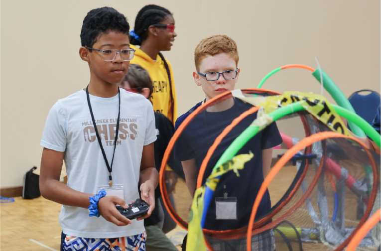 GEMS students flying drones through obstacle courses